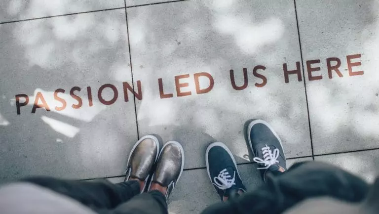 two person standing on gray tile paving