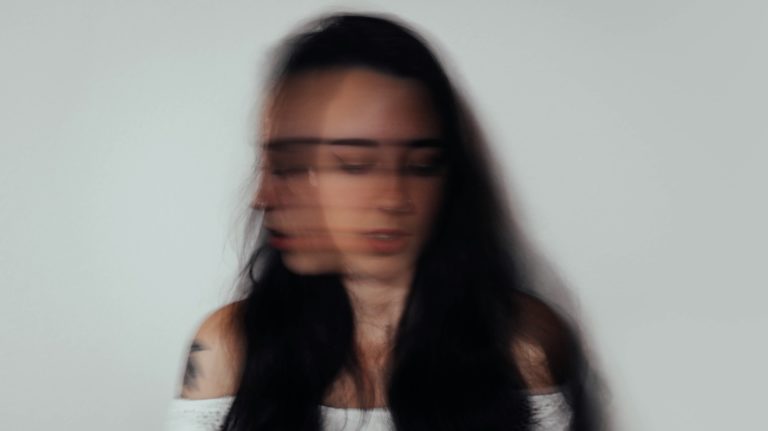 a blurry photo of a woman with glasses